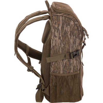 Drake Day Pack in camouflage, featuring padded shoulder straps, mesh side pockets, and compression straps, ideal for outdoor adventures with rugged, water-resistant construction.