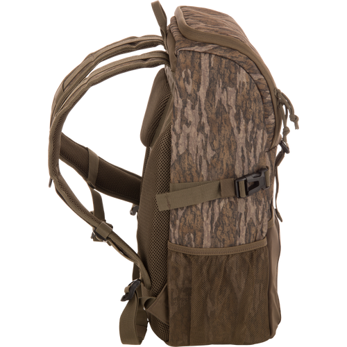 Drake Day Pack in camouflage, featuring padded shoulder straps, mesh side pockets, and compression straps, ideal for outdoor adventures with rugged, water-resistant construction.