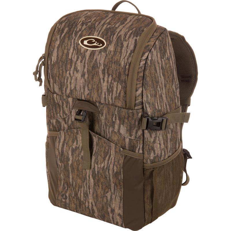 Drake Day Pack, a medium-sized camo backpack with padded straps, side mesh pockets, and a top flap, ideal for outdoor adventures with rugged, water-resistant construction.