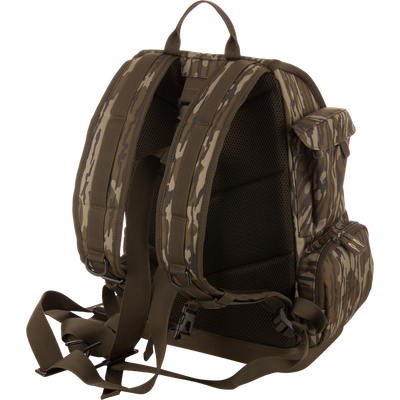 Back view of the Tree Hugger Timber Day Pack with padded straps, mesh panel, waist belt, side zippered pockets, and top handle, ideal for rugged outdoor excursions.