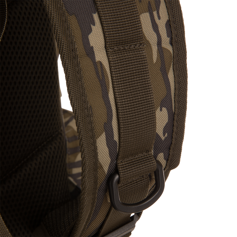 Close-up of Tree Hugger Timber Day Pack's camo-patterned shoulder strap, featuring padded mesh backing, heavy nylon webbing, and plastic D-ring for attachment.