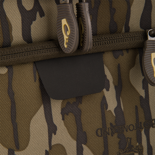 Tree Hugger Timber Day Pack close-up showing camouflage fabric with dual zipper pulls and velcro patch, emphasizing durability and functionality for outdoor excursions.