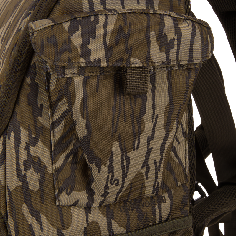 Tree Hugger Timber Day Pack close-up showing camouflage pattern, front pouch with flap, shoulder strap, and mesh backpad, highlighting its rugged, weather-resistant design for hunting excursions.