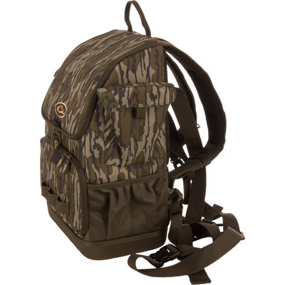 Camouflage-patterned Tree Hugger Timber Day Pack with multiple pockets, padded straps, and waterproof features, designed for outdoor excursions and hunting gear storage.