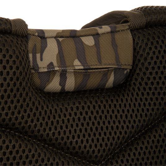 Close-up of the Tree Hugger Timber Day Pack's padded mesh back-panel with camouflage nylon handle, showcasing its rugged design for outdoor hunting adventures.
