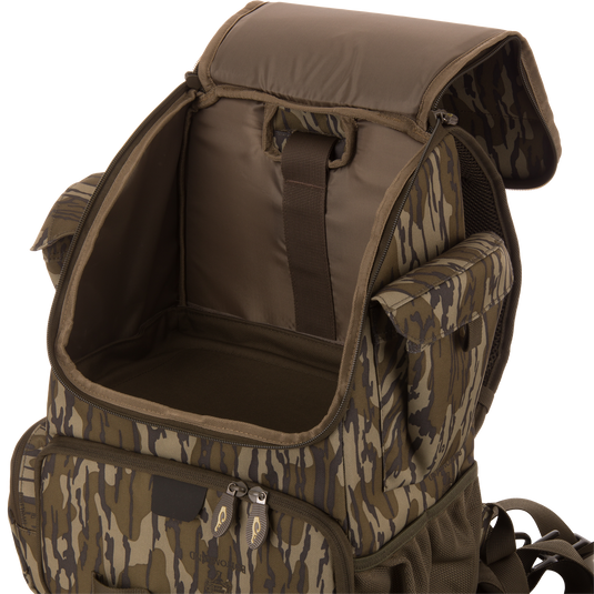 Tree Hugger Timber Day Pack with open main compartment, side pouches, front zip pocket, adjustable straps, showcasing its rugged, water-resistant design for outdoor adventures.