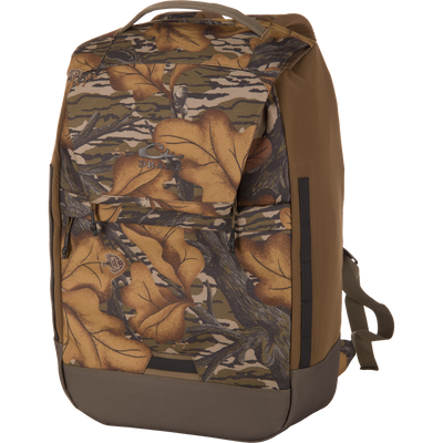 CommandXT Quick Load Pack with camouflage leaf pattern and Drake logo, featuring durable, water-repellent fabric, quick-access main compartment, and padded shoulder straps for outdoor use.