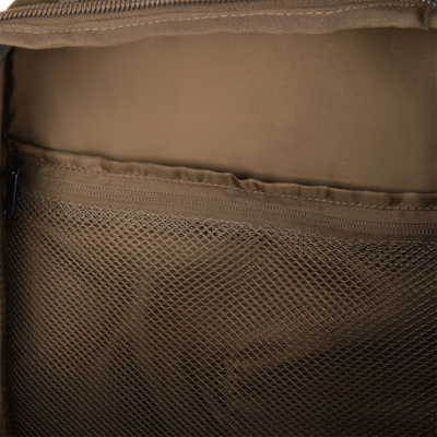 Close-up of the Campus Backpack's tan nylon interior, showing fabric lining, a top zipper, and a mesh inner pocket for small item organization.