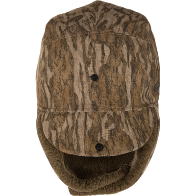 LST BMF Bomber Hat with Primaloft, featuring wood-grain camouflage, fleece lining, ear flaps, and adjustable toggle for cold-weather hunting comfort and protection.