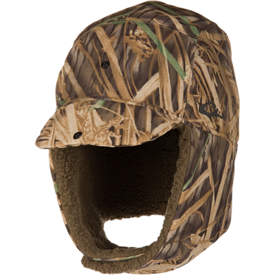 Camo-patterned LST BMF Bomber Hat with Primaloft, featuring ear flaps, sherpa fleece lining, and water-resistant outer for warmth in harsh hunting conditions.