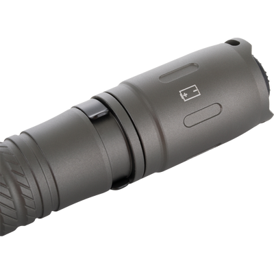 Lumen Flashlight EVO500 close-up showing metal housing, pocket clip, and battery-polarity icon, highlighting its compact design and functionality for versatile use in hunting and outdoor activities.