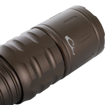 Lumen Turbo Flashlight EVO2200 close-up, showcasing its rugged aluminum body with grip grooves, part of the bezel, highlighting durability and high-performance lighting features.