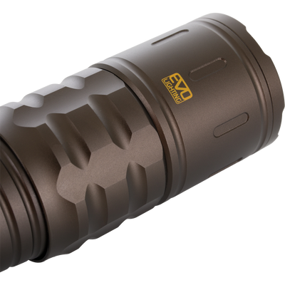 Close-up of the Lumen Turbo Flashlight EVO2200, showcasing its knurled anodized-metal body, yellow EVO Lighting logo, and screw-on head, highlighting rugged, high-performance design.