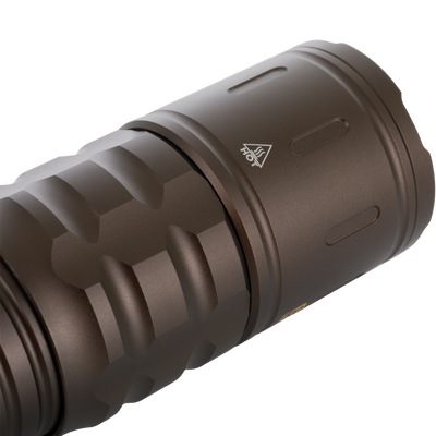 Lumen Turbo Flashlight EVO2200 head showing knurled anodized cylinder with cooling grooves and HOT warning, emphasizing rugged, high-performance design for extreme conditions.