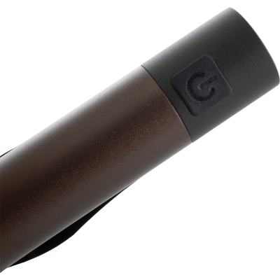 Close-up of the Cap Light's power button, showcasing its compact design. This versatile cap light features a 360° pivoting clip for hands-free illumination.