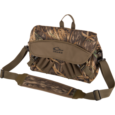 Drake Hardline Shoulder Blind Bag featuring a camouflage pattern, multiple pockets, padded shoulder strap, and molded logo, designed for durable, waterproof hunting gear storage.