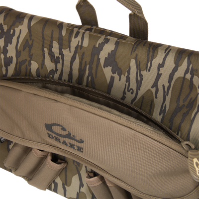 Close-up of Drake's Hardline Shoulder Blind Bag, showcasing padded handles, SBS coil zippers, and compact design, ideal for waterfowl hunting gear protection.