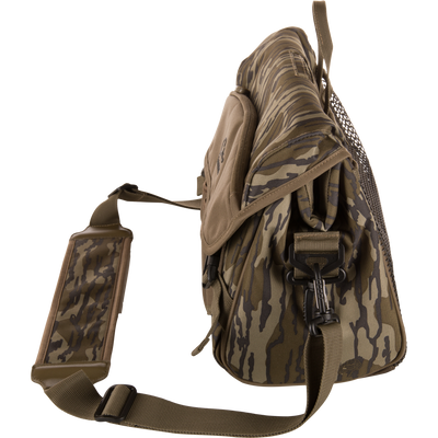 Hardline Shoulder Blind Bag in tiger-stripe camouflage with padded strap, mesh pocket, front flap, and attachment points, designed for durable, waterproof hunting gear storage.