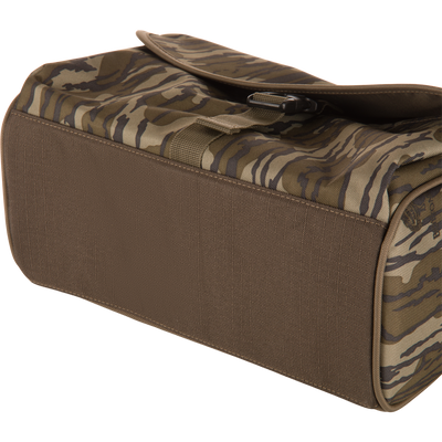Hardline Blind Bag: A durable, water-resistant tactical bag with a tiger-stripe camo flap and buckle, designed for waterfowl hunters to keep gear organized and dry.