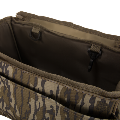 Hardline Blind Bag interior with camouflage pattern, featuring stitched pockets, dividers, a zipper, and a D-ring clip for securing small hunting essentials.
