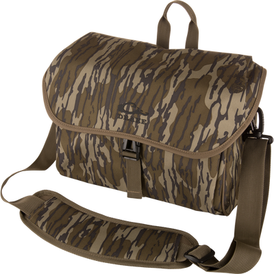 Camouflage-patterned Hardline Blind Bag with quick-release buckle, padded adjustable strap, and DRAKE logo, designed for waterfowl hunters to keep gear dry and protected.
