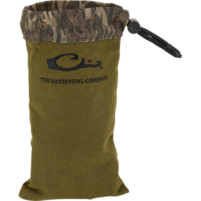 Waxed Canvas Shell Pouch with camo-print cuff and drawstring closure, featuring “C” logo and “THE WATERFOWL COMPANY,” designed for durable, all-weather hunting gear storage.