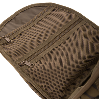 Close-up of Hardline Sling Pack's interior, showcasing diamond-patterned mesh pockets and dual SBS zippers, highlighting its rugged, water-repellent design for organized outdoor gear storage.