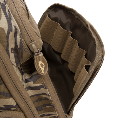 Hardline Sling Pack close-up showing camouflage exterior and interior with elastic loops for organizing small items, ideal for hunting and outdoor use.