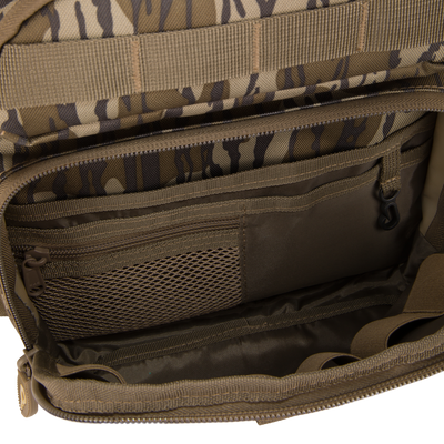 Hardline Sling Pack's interior with MOLLE loops, mesh pocket, and compartments, designed for organized gear storage, reflecting rugged durability for outdoor and everyday use.