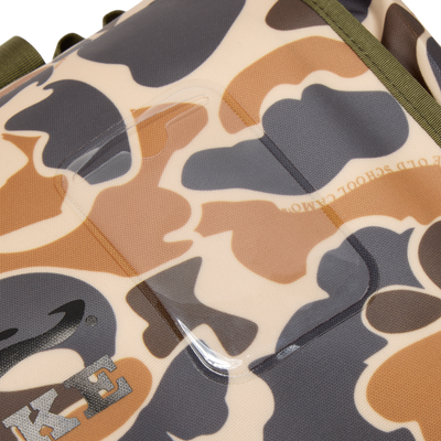Close-up of Waterproof Duffel Bag's camouflage fabric, showcasing part of Nike swoosh, olive-green webbing, and clear ID tag holder stitched into material.