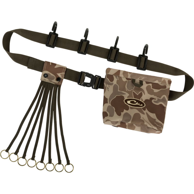 Alt text: The Ultimate Timber Strap by Drake Waterfowl, featuring a camouflage bag with logo, adjustable tree strap, Spring-Open™ shell pouch, and metal hooks for hunting gear organization.