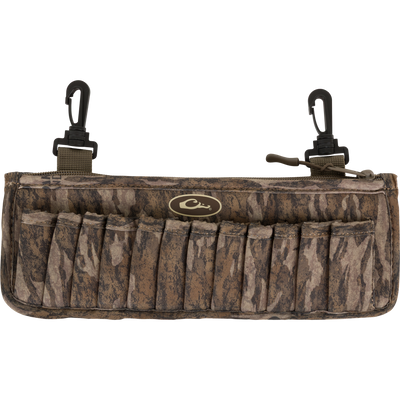 Neoprene Shell Clip with camo pattern, featuring 24 elastic loops for shotgun shells and two black swivel clips for attachment; includes a zippered pocket for accessories.