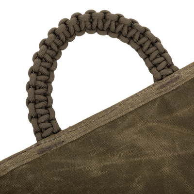 Close-up of the Wax Cotton Gun Sleeve's braided paracord handle sewn onto rugged canvas, highlighting its durable design for hunters' shotgun protection.