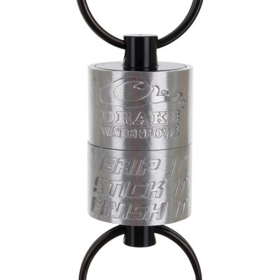 Drake Finisher Magnetic Retractor for waterfowl hunting, featuring two black rings and engravings that read Drake Waterfowl and Grip It Stick It Finish It.