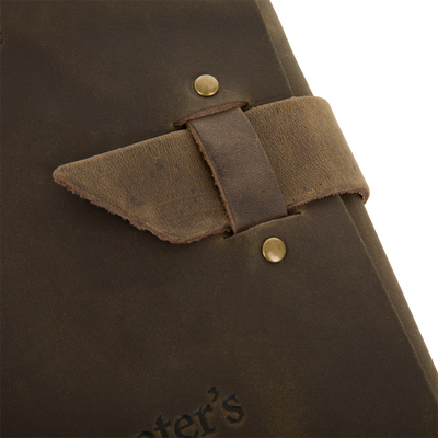 Close-up of Drake Leather Wingshooters Hunting Log, featuring distressed leather cover with embossed lettering and a brass snap, designed for detailed hunting record-keeping.