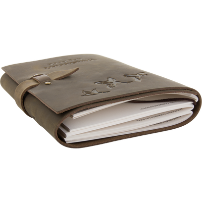 Drake Leather Wingshooters Hunting Log: Brown leather journal with embossed bird silhouettes, wrap-around strap, and insert sheets for documenting detailed hunting experiences.