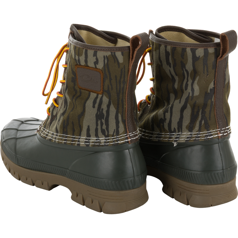 Throwback 80 Waxed Canvas Lace Up Duck Boot with camo canvas upper, waterproof rubber base, and orange-yellow laces, designed for durability and comfort in rugged outdoor conditions.