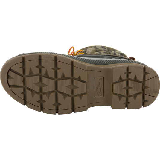 Throwback 80 Waxed Canvas Lace Up Duck Boot sole, showcasing lugged tread pattern, with glimpses of camouflage upper and orange laces, highlighting durability and water-resistance.