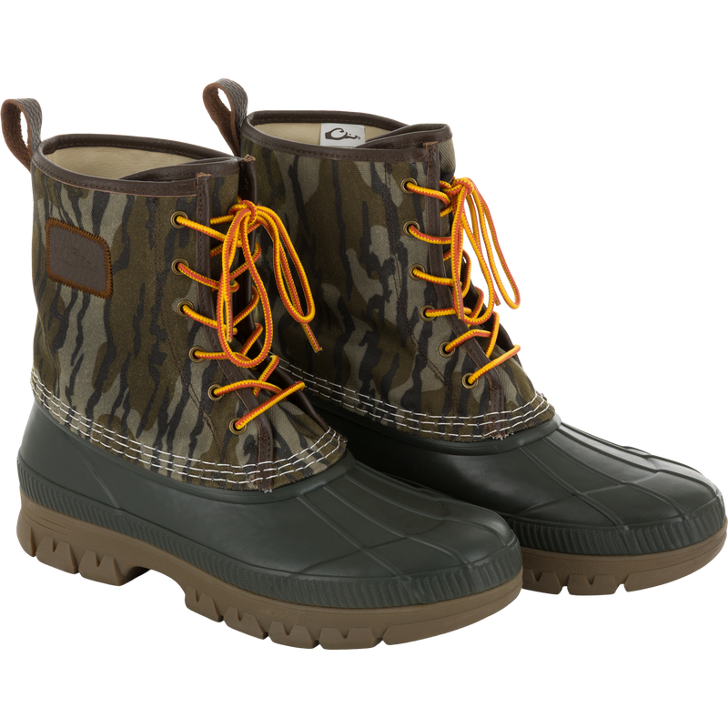 Throwback 80 Waxed Canvas Lace Up Duck Boot with waterproof rubber bottom, camo-print canvas upper, yellow-and-orange laces, ideal for wet and rugged outdoor conditions.