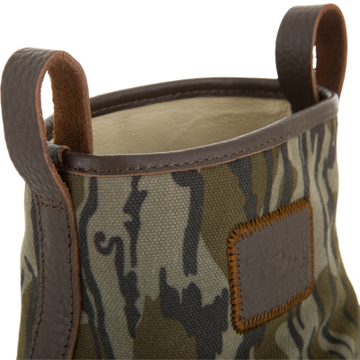 RTL - Throwback 80 Waxed Canvas Slip On Duck Boot with camouflage-patterned fabric, dark brown leather trim, and pull loops, designed for durability and water resistance.