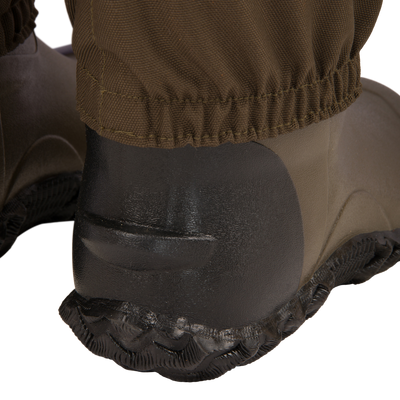 Close-up of Hardline Uninsulated Breathable Wader's rubber boot heel and outsole, showcasing durable design and waterproof pant cuff for outdoor reliability.