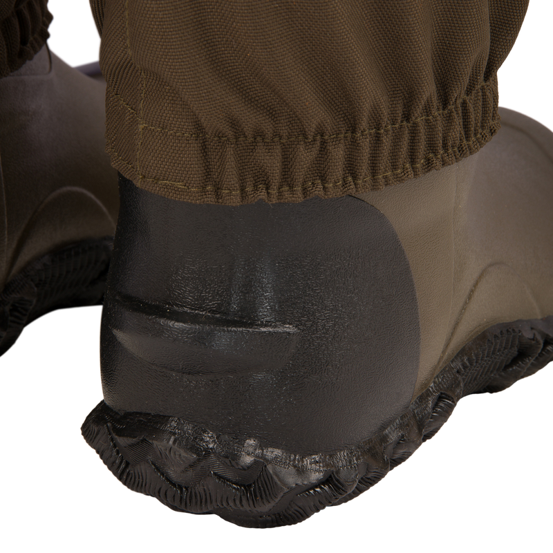 Close-up of Hardline Uninsulated Breathable Wader's rubber boot heel and outsole, showcasing durable design and waterproof pant cuff for outdoor reliability.