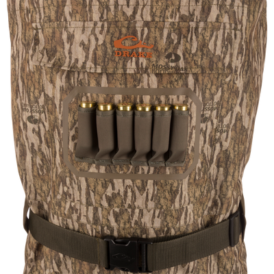Drake Hardline Uninsulated Breathable Wader with Mossy Oak pattern, featuring a chest cartridge pocket with shotgun shell loops and adjustable waist belt for hunting.