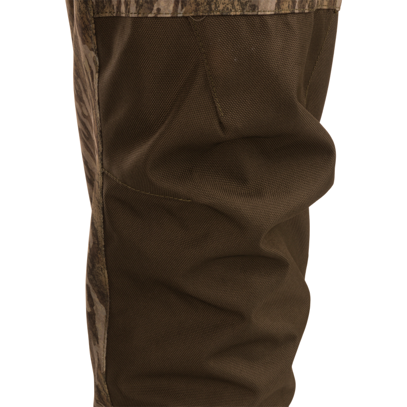 Hardline Uninsulated Breathable Wader featuring reinforced ballistic fabric with camouflage panels, showcasing the textured knee area, ideal for outdoor and hunting adventures.