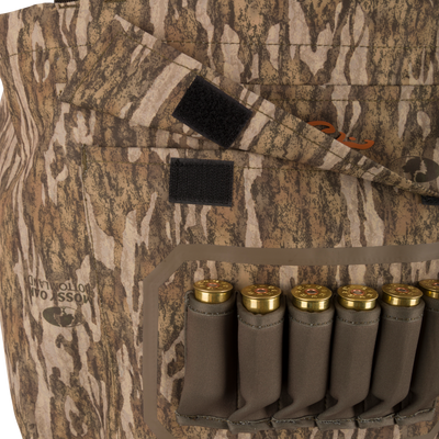 Hardline Uninsulated Breathable Wader with Mossy Oak Bottomland camo, featuring a Velcro flap and built-in ammo carrier loaded with shotgun shells.