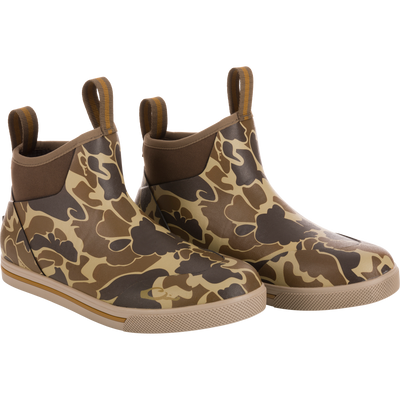 Camp Deck Boot in camouflage print; ankle-height, slip-on style with waterproof neoprene, rubber sole for traction, and pull-tabs for easy wear.