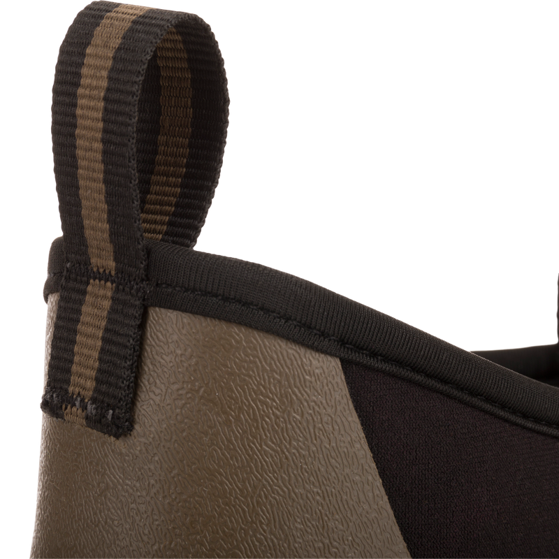 Camp Deck Boot close-up showing textured rubber lower and neoprene upper with striped pull-tab, highlighting its waterproof design and superior traction for outdoor adventures.