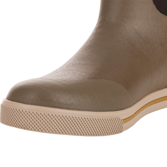 Close-up of Camp Deck Boot showcasing its light brown molded rubber toe and textured sole, highlighting waterproof construction and superior traction ideal for outdoor adventures.