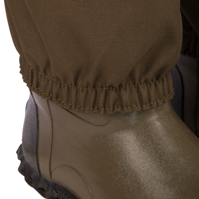 Hardline Insulated Breathable Wader close-up, showcasing the elastic-cuffed pant leg over an olive waterproof boot, designed for warmth and durability in outdoor conditions.
