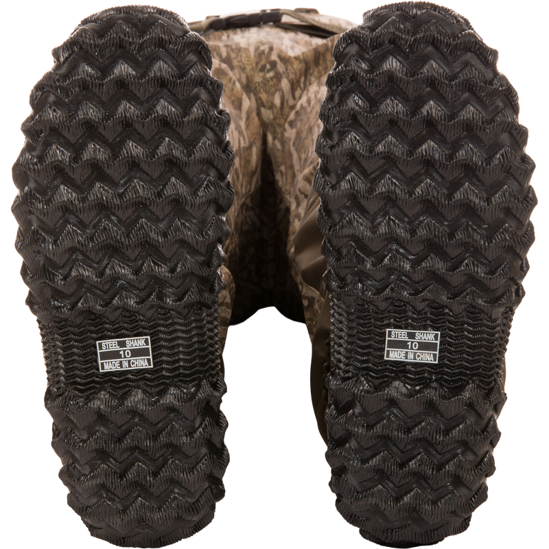 Underside view of Hardline Insulated Breathable Wader boots showing camo-pattern, zig-zag tread, and STEEL SHANK 10 MADE IN CHINA label.